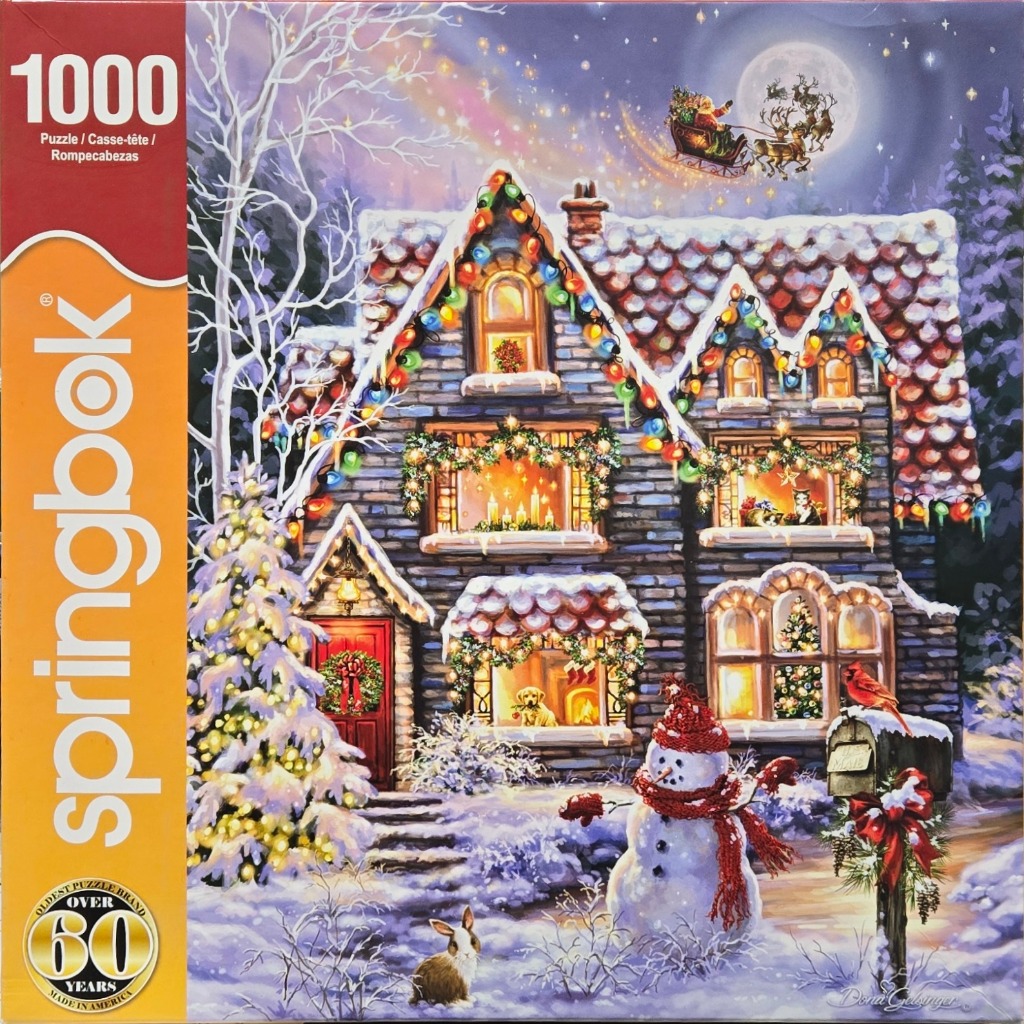 A cozy stone house decorated for Christmas with a snowman and Santa