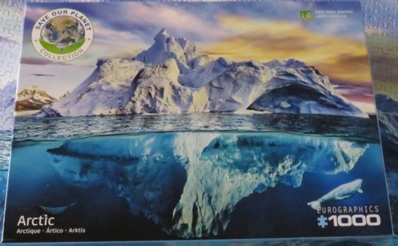 Split-level view of an iceberg showing the snowy peak above water and the deep blue mass submerged below.