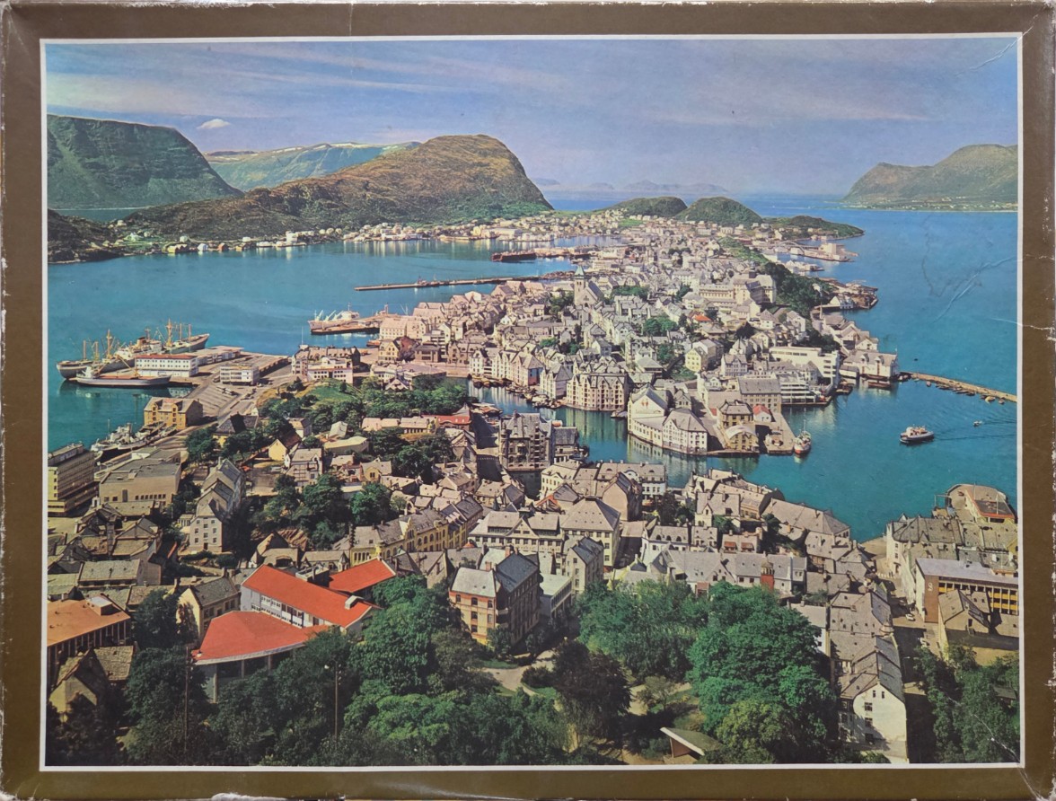 Aerial view of Alesund, Norway, featuring a coastal town with Art Nouveau buildings, harbor, and surrounding mountains.