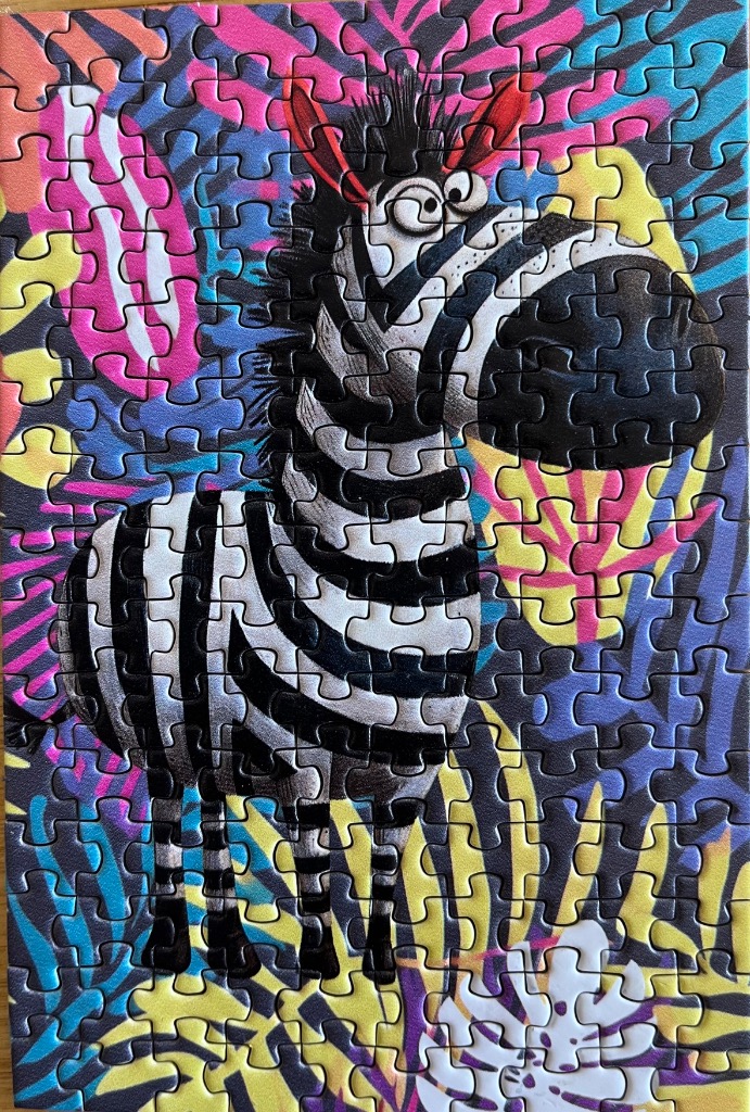 Cartoon zebra with a large snout against a bright, colorful abstract jungle background
