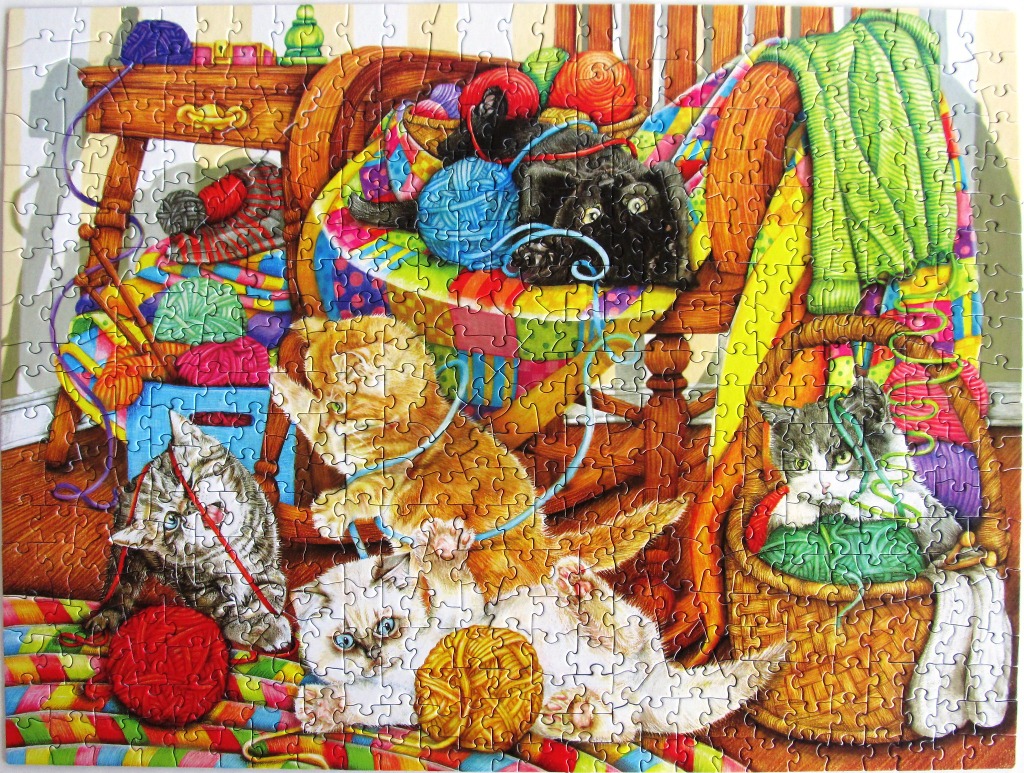 Five colorful kittens playing with balls of yarn in a cozy room