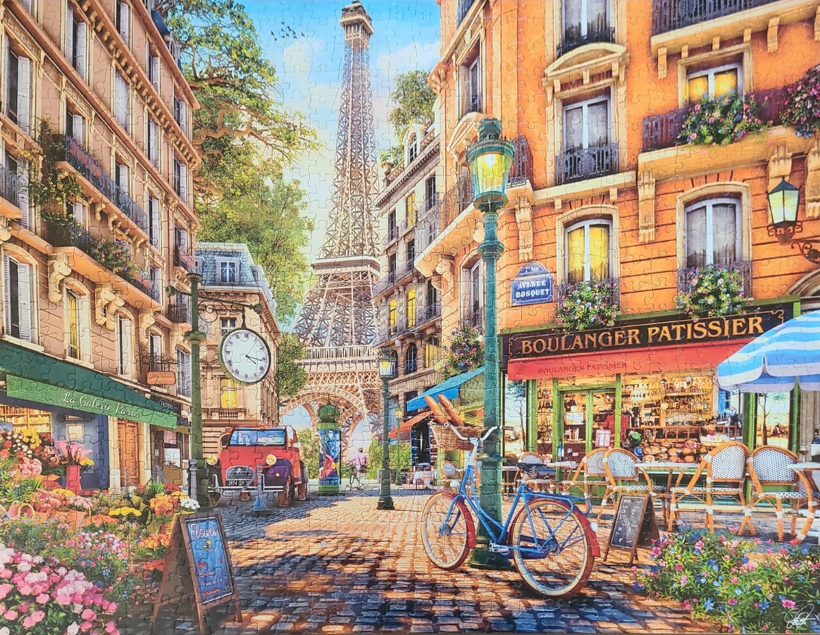 A sunny Parisian street scene featuring a view of the Eiffel Tower, a bakery, and a flower shop.