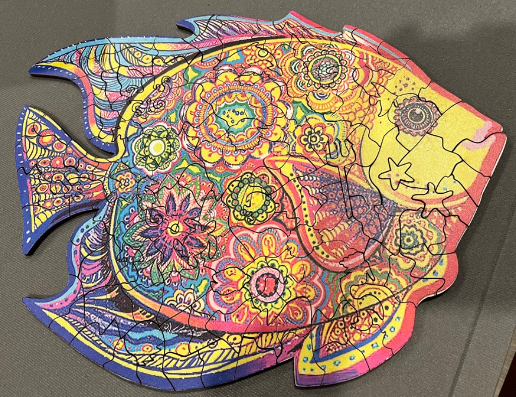 A shaped fish illustration featuring colourful, intricate mandala-style floral patterns.