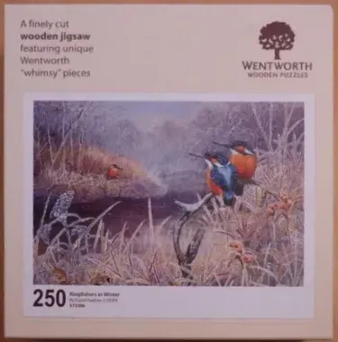 Two kingfishers perched on a branch near a frost-covered riverbank in winter