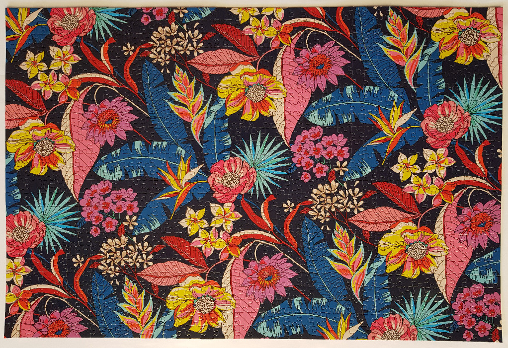 A lush, tropical botanical pattern featuring vibrant flowers and foliage on a dark navy background.