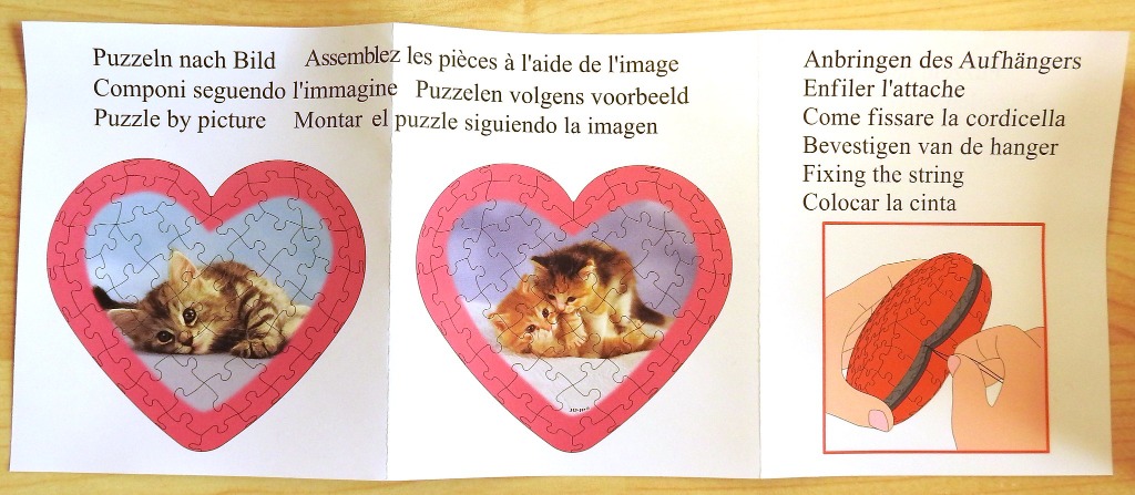 Instructions showing two heart-shaped kitten illustrations and a diagram for attaching a string.