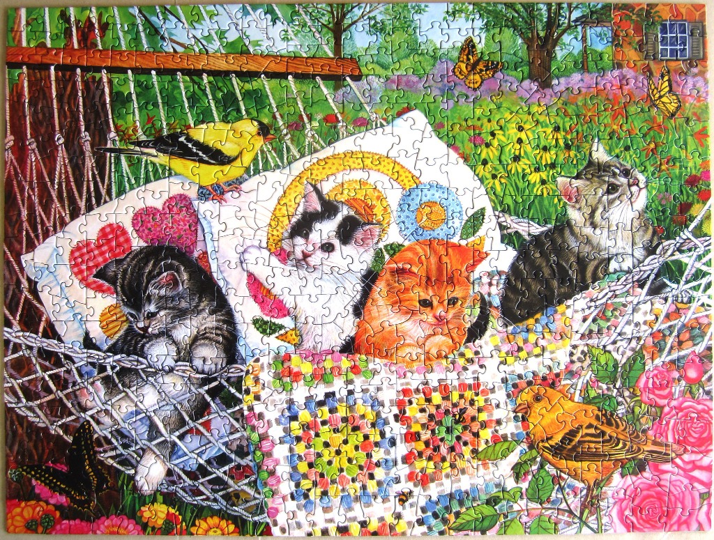 Four kittens resting in a hammock surrounded by a colorful garden with birds and butterflies.