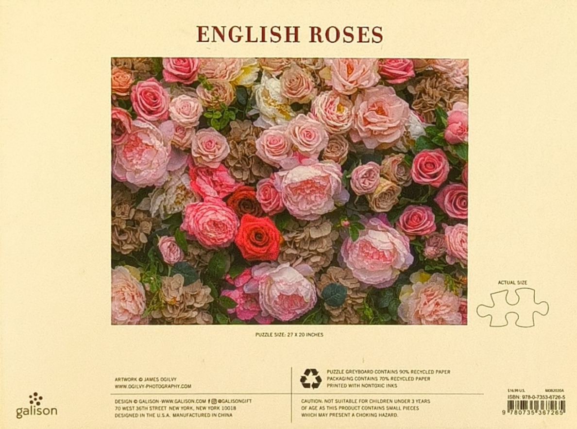 A dense arrangement of pink, peach, and cream-colored English roses.