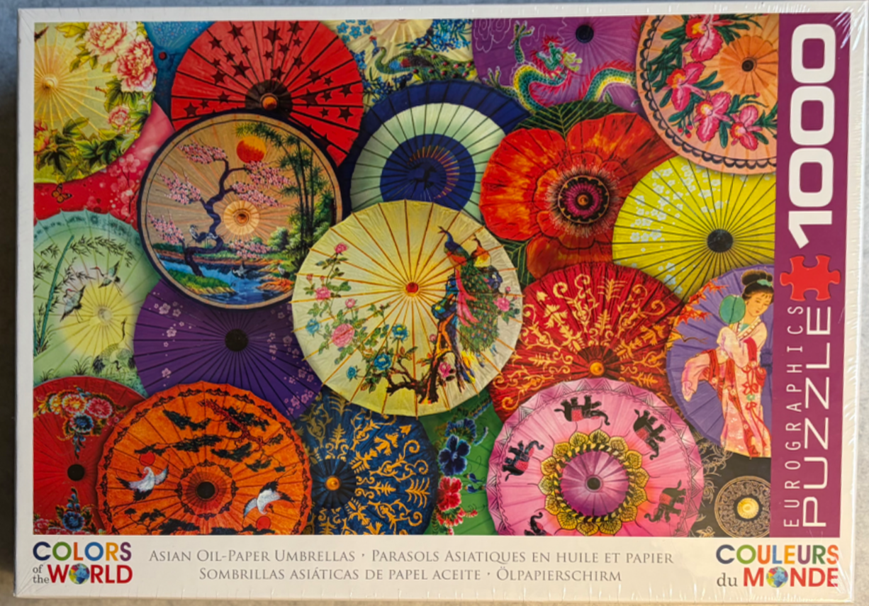 A collage of vibrant, overlapping Asian oil-paper parasols featuring traditional floral, animal, and landscape designs.