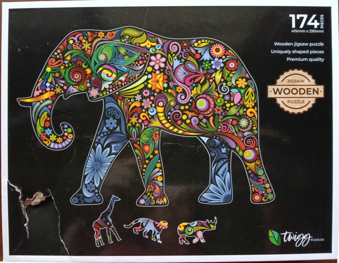 A stylized elephant and three smaller animals decorated with vibrant, colorful floral and paisley patterns on a black backgro