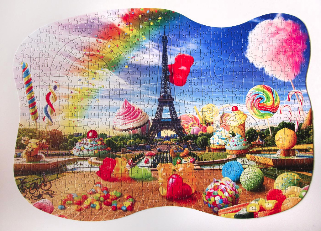 Eiffel Tower surrounded by a surreal landscape of giant sweets and colorful candy