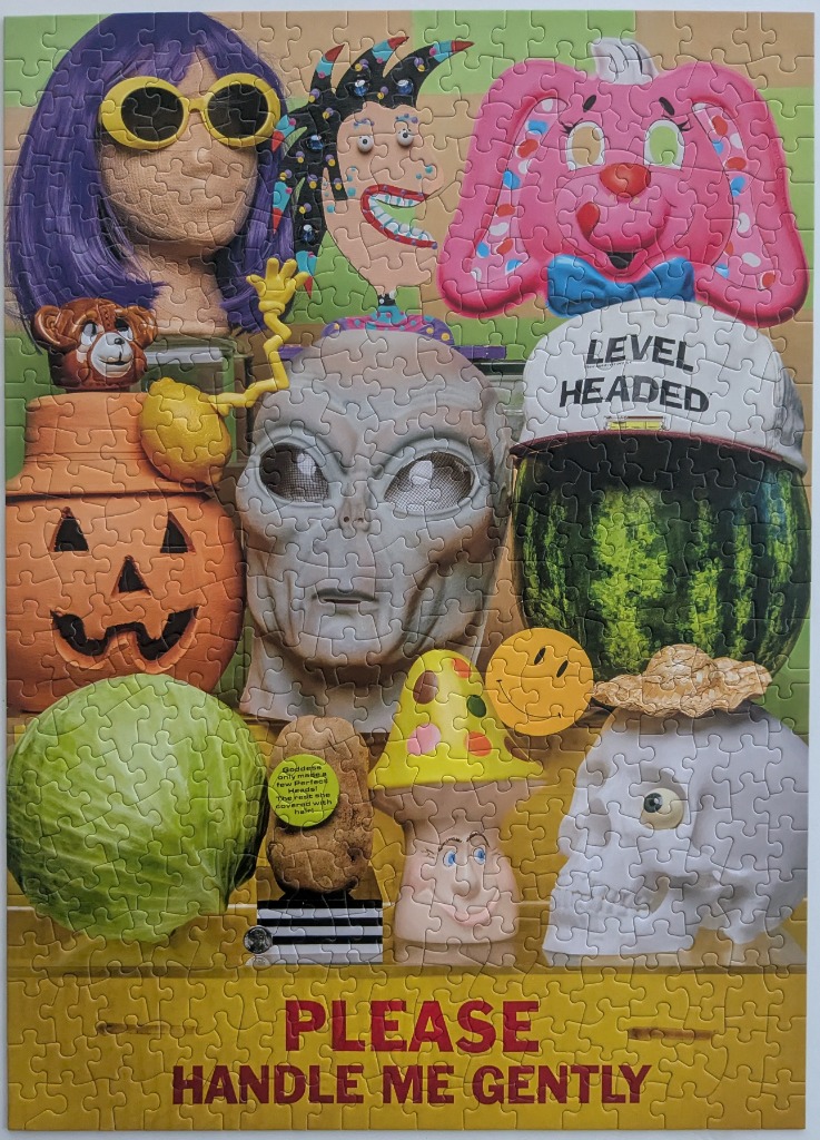 A whimsical collection of eclectic objects, masks, and oddities arranged on shelves.