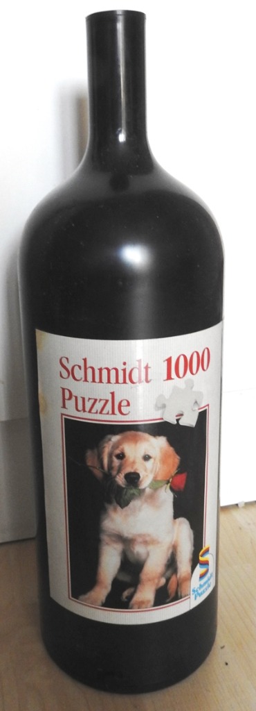 A puppy holding a red rose in its mouth, depicted on a label on a black wine-bottle-shaped container.