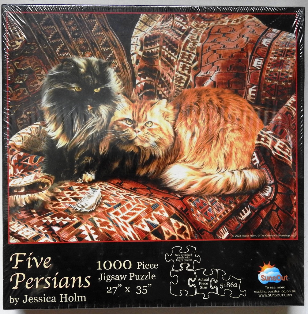 A black long-haired cat and an orange tabby cat sitting on a patterned rug.
