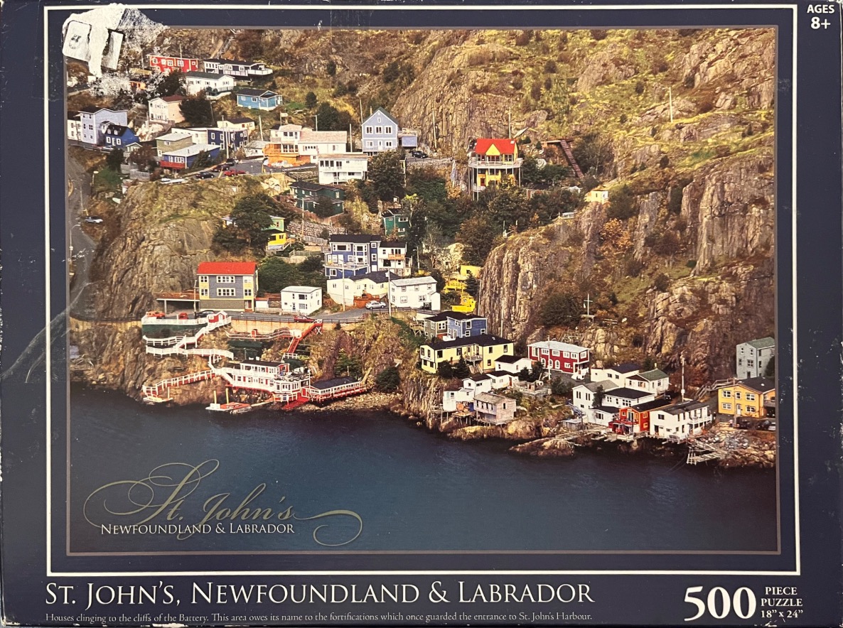 A scenic photograph of colorful houses built into the steep rocky cliffs overlooking the harbor in St. John's, NL.
