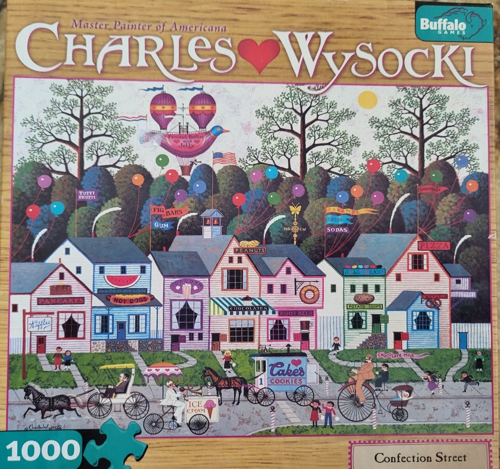 Whimsical folk art street scene featuring shops labeled with food names, horse-drawn carriages, and floating balloons.