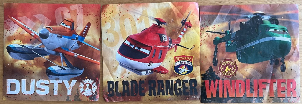 Three stylized anthropomorphic aircraft characters: an orange plane, a red helicopter, and a green cargo helicopter.