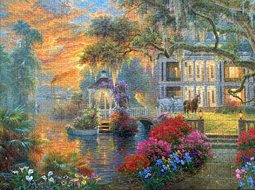 A Southern plantation house at sunset with a gazebo, horse-drawn carriage, and blooming gardens by a river.