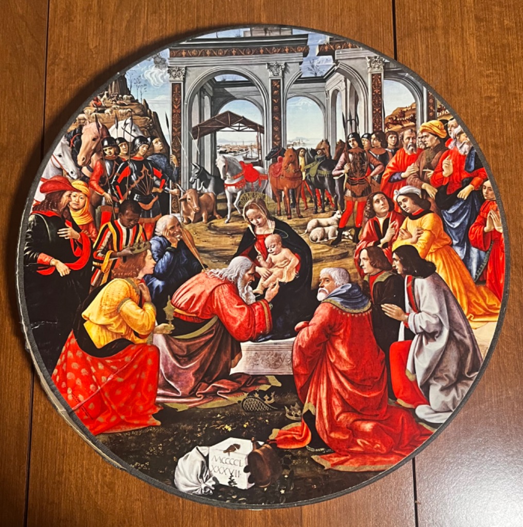 Renaissance painting of the Adoration of the Magi set in a classical architectural landscape.