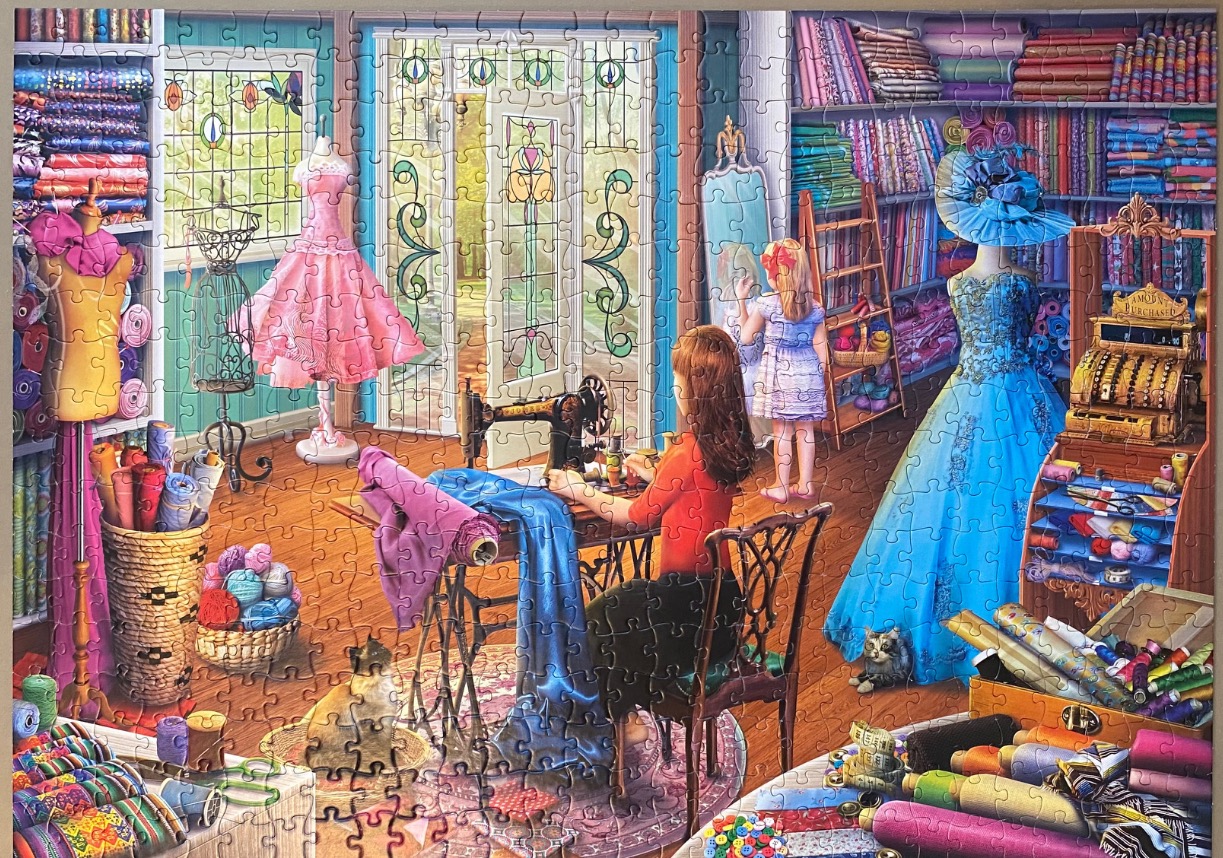An illustration of a woman sewing in a vibrant fabric shop filled with bolts of cloth, dresses, and a cat.