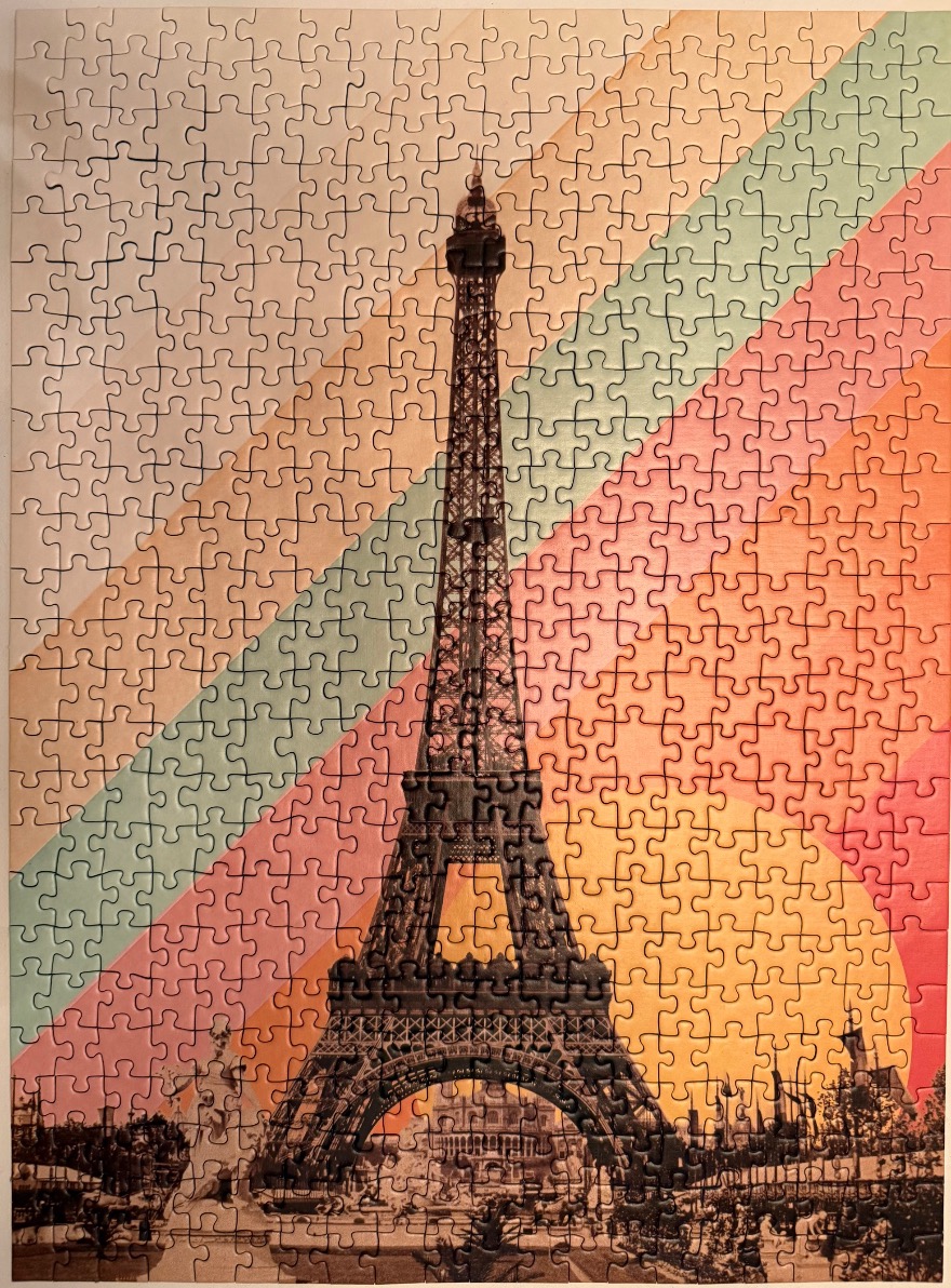 Eiffel Tower centered against a background of diagonal pastel rainbow stripes in a retro style