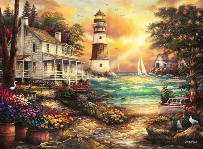 A lighthouse stands by the sea next to a white house with stone paths and vibrant flower gardens at sunset.