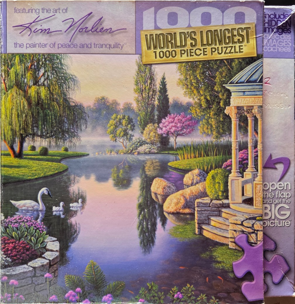 A peaceful lakeside garden scene with a gazebo, willow tree, and swans swimming in calm water at sunset.