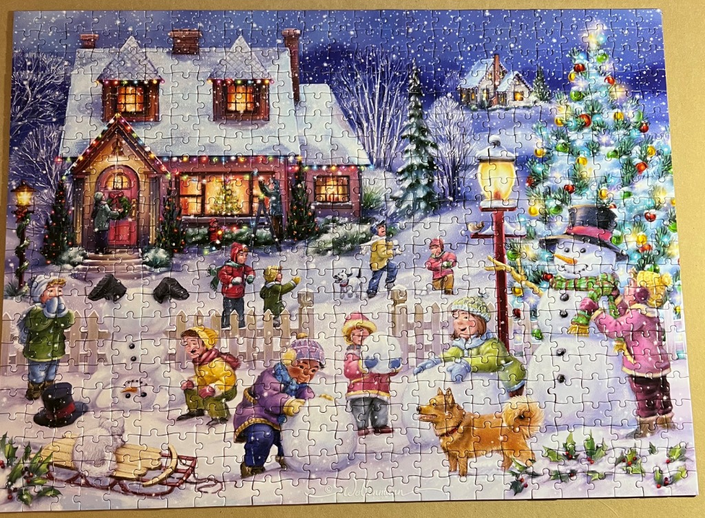 A whimsical winter scene featuring children playing in the snow outside a decorated cottage and a glowing Christmas tree.