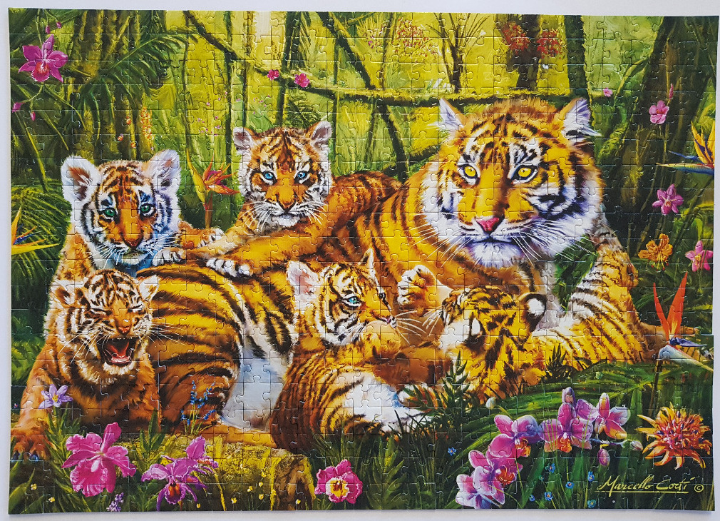 A mother tiger with four cubs resting in a lush tropical jungle filled with exotic flowers.