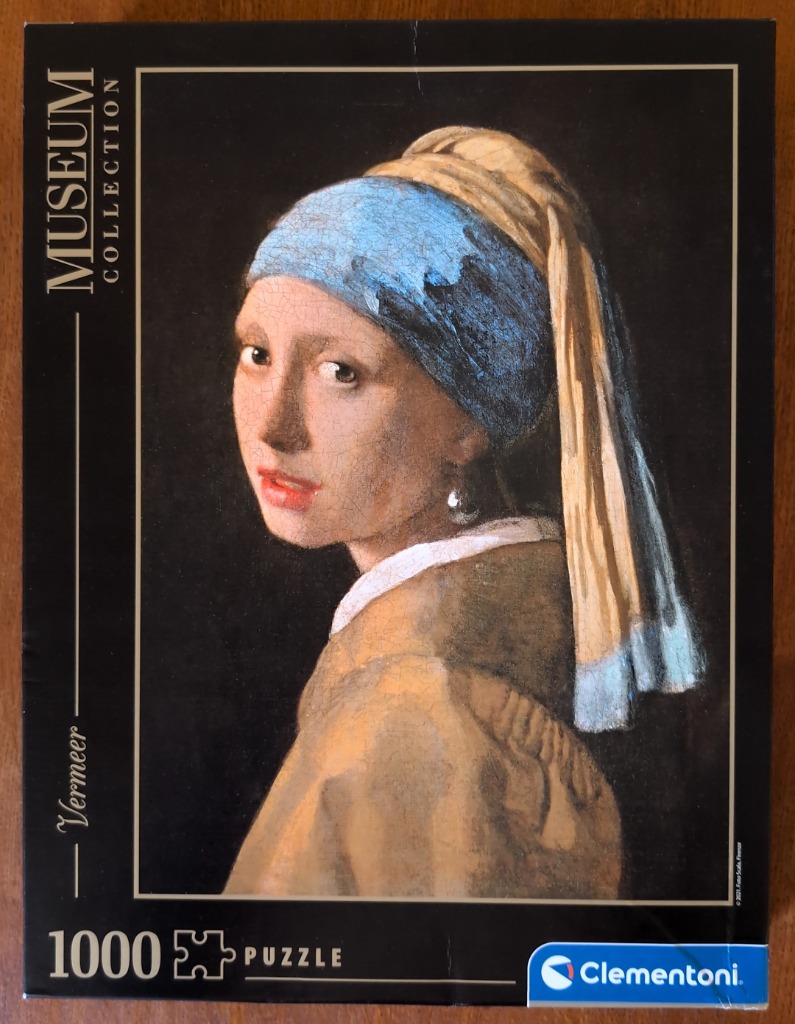 Johannes Vermeer's Girl with a Pearl Earring, an oil painting of a young woman with a blue and gold turban.