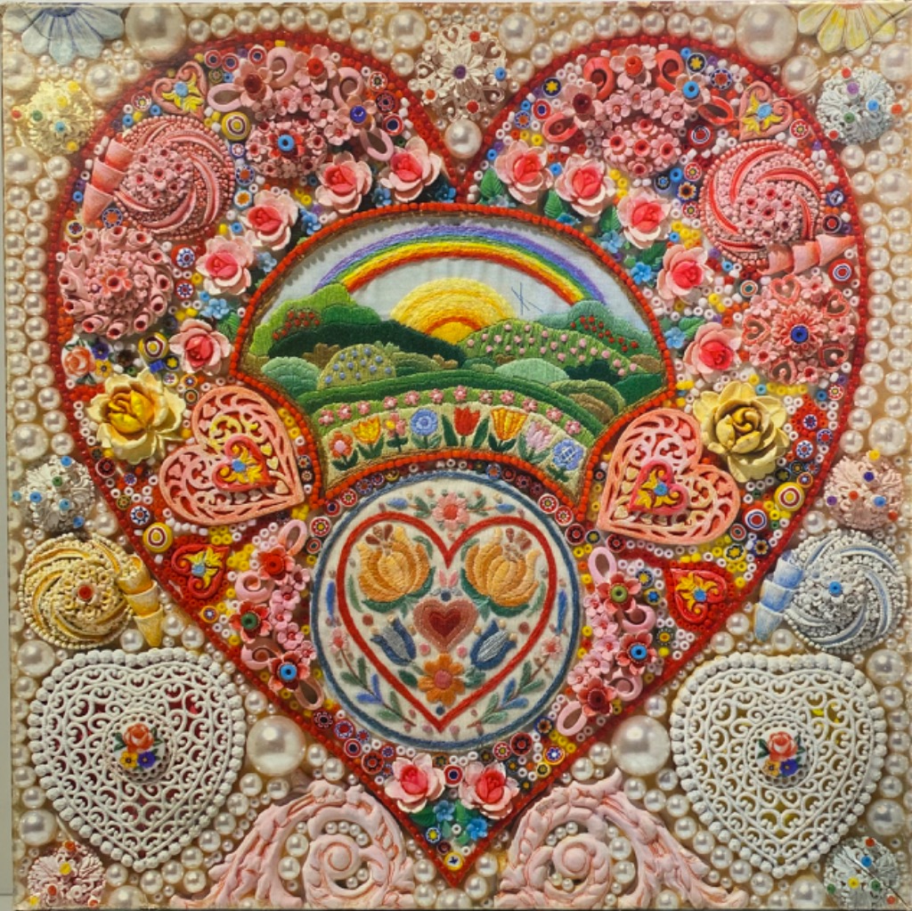 Intricate, heart-shaped mixed-media art piece featuring embroidery, beads, and lace ornaments in soft pastel colours.