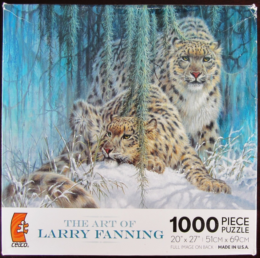 Two snow leopards resting in a snowy, blue-toned forest