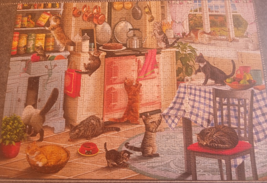 A kitchen filled with numerous playful cats in a busy, warm-toned illustration.