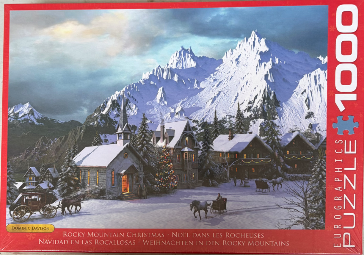 A snow-covered alpine village nestled before towering, jagged, snow-capped mountains at dusk.