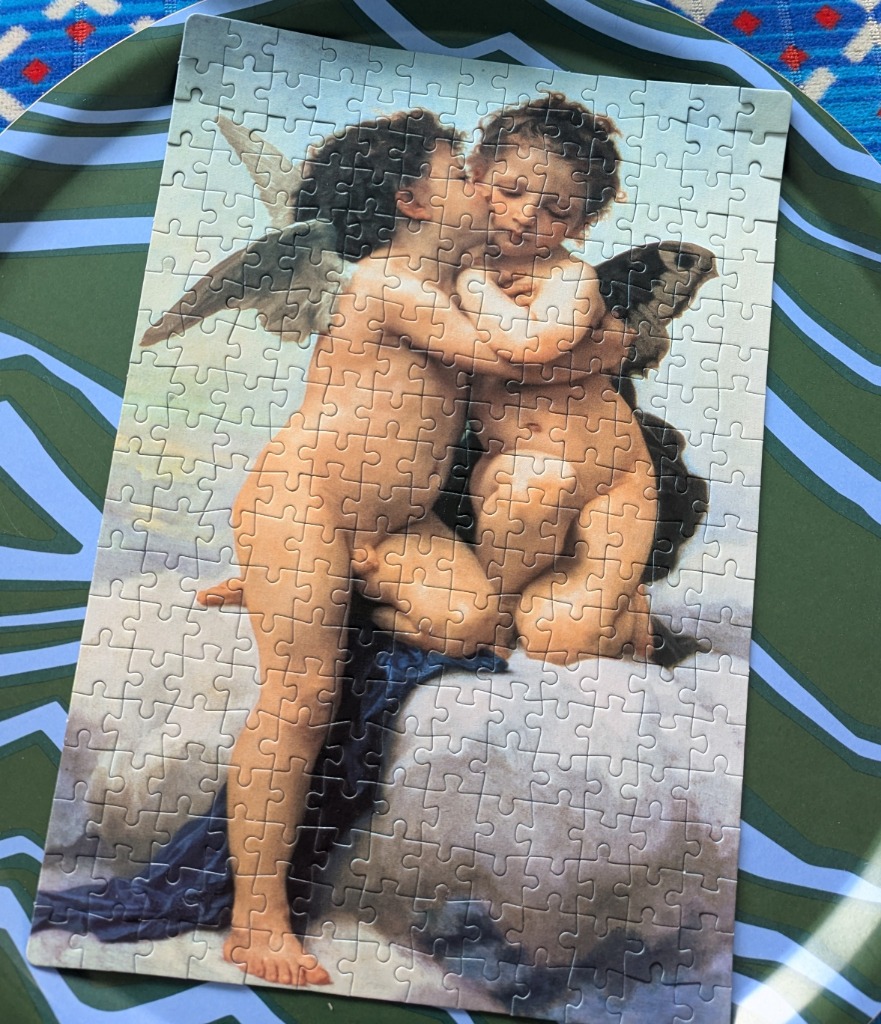 A classical oil painting showing two cherubs embracing and kissing against a cloudy sky.