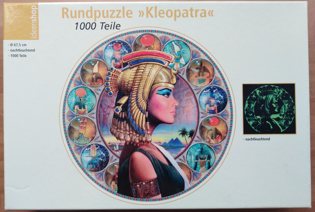 An illustration of Cleopatra in profile, surrounded by a ring of smaller circular portraits of Egyptian deities.