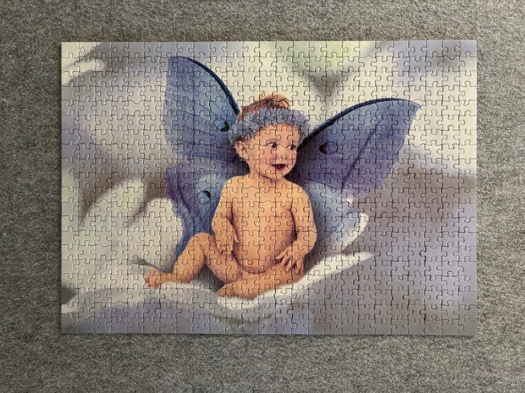 A whimsical illustration of a baby with fairy wings sitting on a cloud.