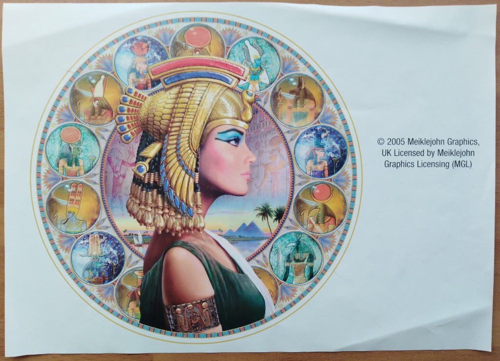 An illustration of an Egyptian queen in profile, framed by a circular border of smaller portraits of Egyptian deities.
