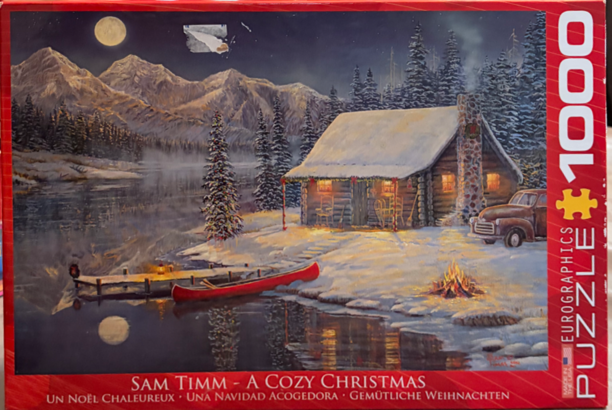 A moonlit winter scene of a log cabin beside a snowy lake with a red canoe, a vintage truck, and a glowing campfire.