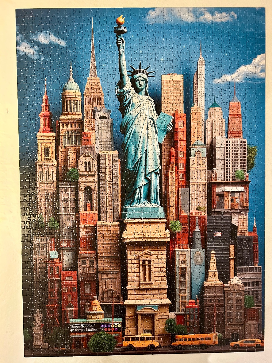 A whimsical collage of New York City landmarks including the Statue of Liberty towering over stylized skyscrapers.