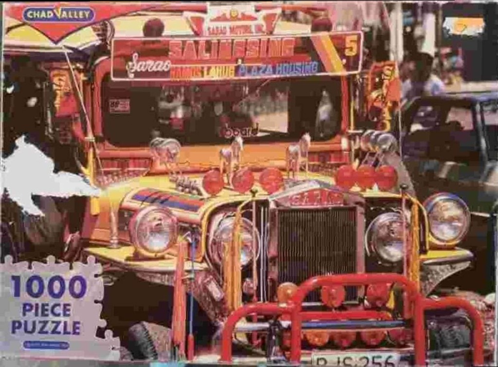 A brightly decorated, yellow Filipino jeepney parked on a street.