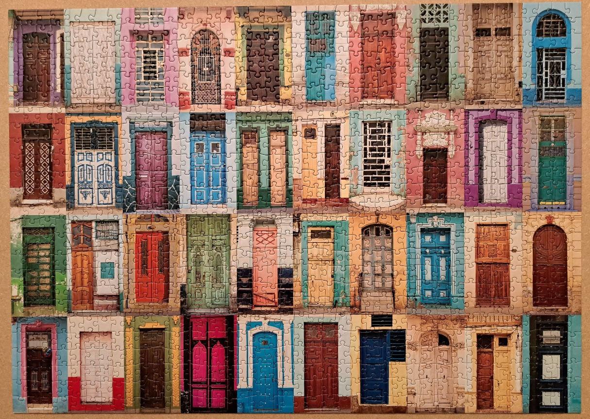 A collage of colourful doors from historic European or Caribbean architecture.
