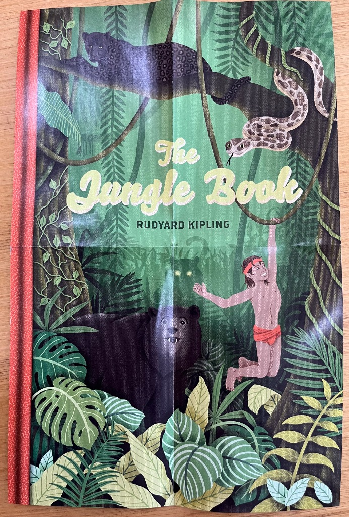 Illustration of Mowgli, Baloo, Bagheera, and Kaa in a lush jungle setting.