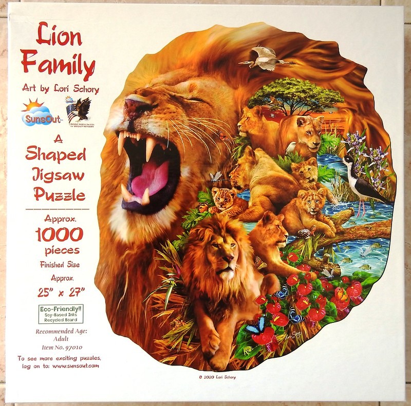 A detailed painting of a lion family set within the silhouette of a large lion
