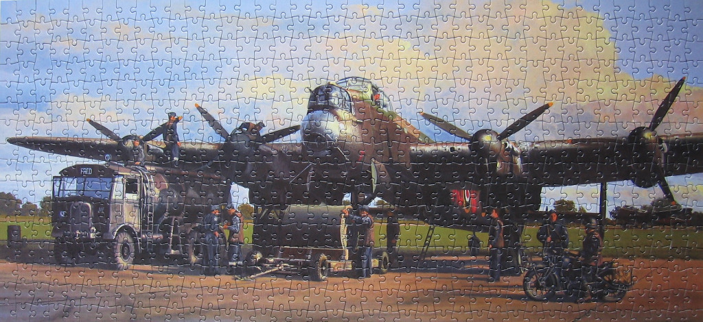 A vintage military bomber aircraft being serviced by ground crew on an airfield at dusk.