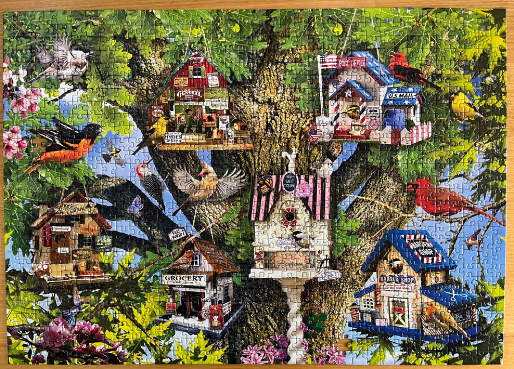 An illustration of several whimsical birdhouses resembling tiny shops hanging from a large, leafy tree.