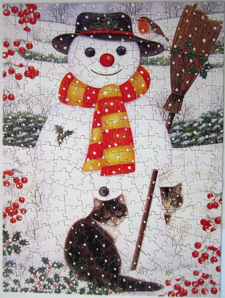 An illustration of a snowman wearing a striped scarf and hat, standing in snow with a robin, a broom, and two cats.