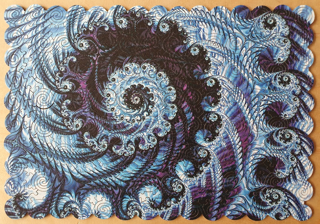 A fractal art image featuring swirling, interconnected spirals in shades of deep blue, purple, and white.