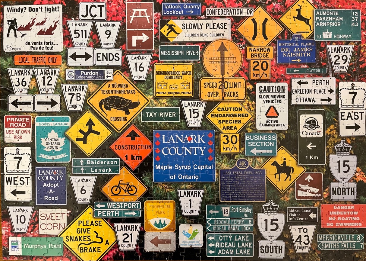A collage of various Canadian road, warning, and informational signs set against a background of foliage.