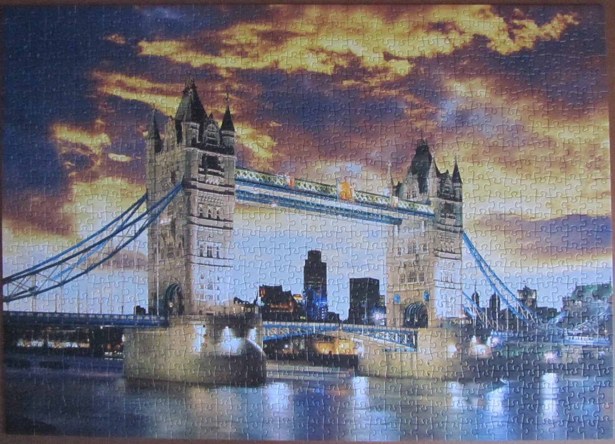 Tower Bridge in London at sunset with a dramatic orange and purple sky.